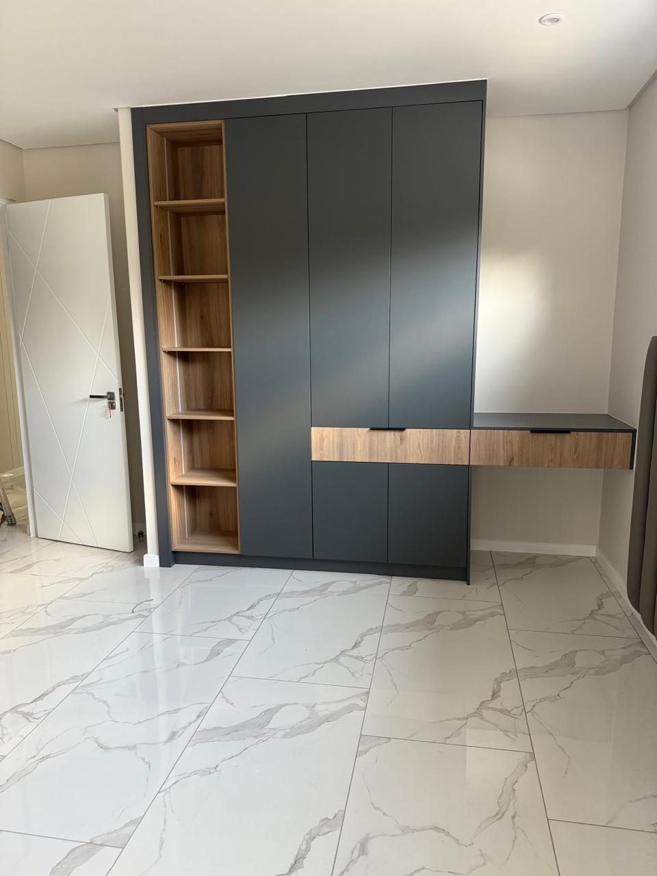 Modern fitted wardrobe and shelving kept clean and orderly